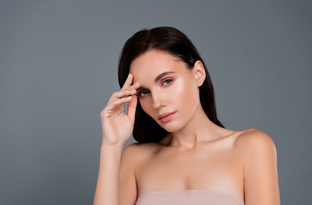 A woman with smooth, radiant skin and defined facial contours, showcasing the aesthetic results of a triLift facial stimulation treatment.